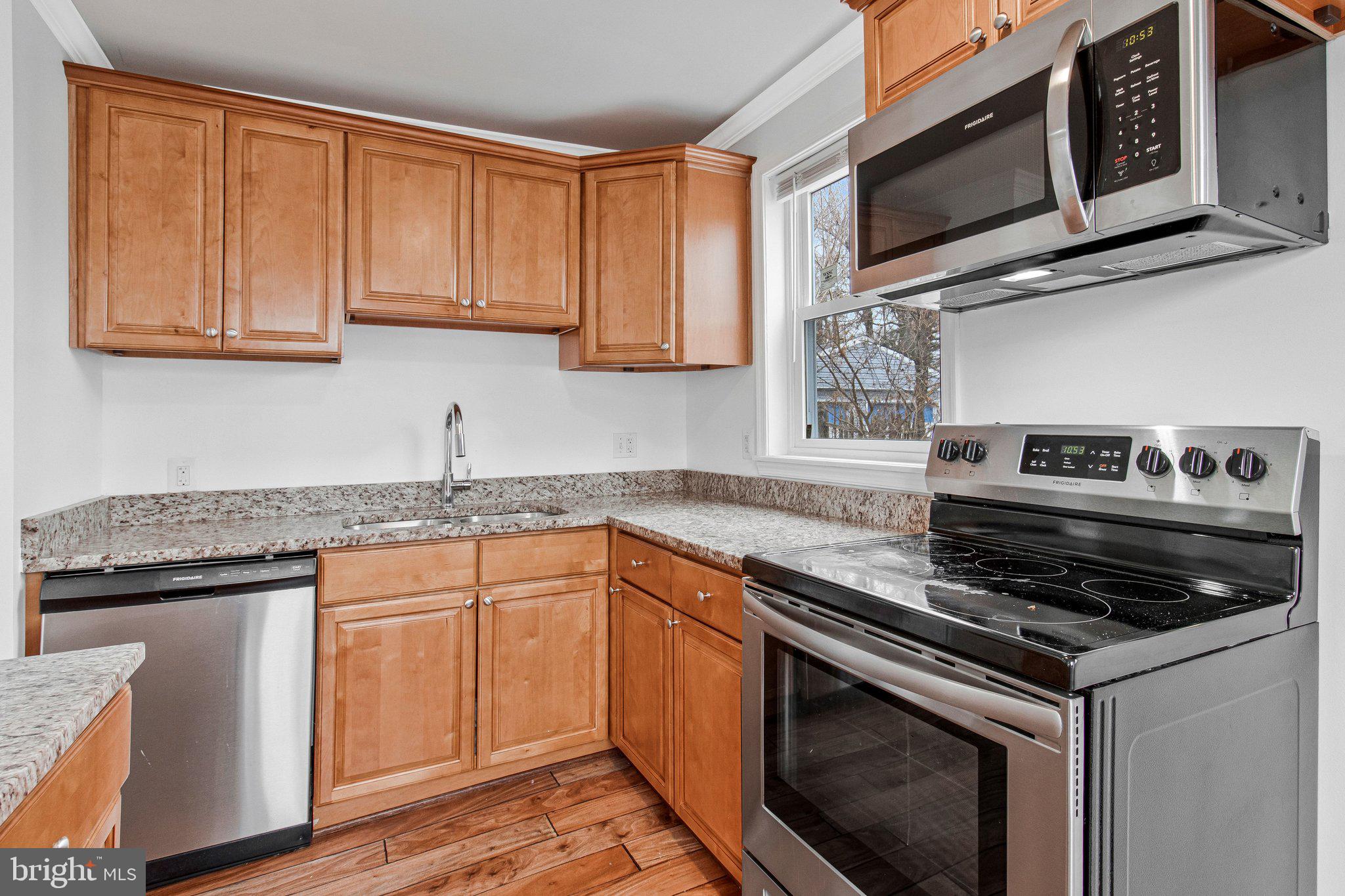 8600 Lantern Lane Clinton, MD 20735 - Photo 14 of 40 a kitchen with stainless steel appliances granite countertop a stove and a microwave