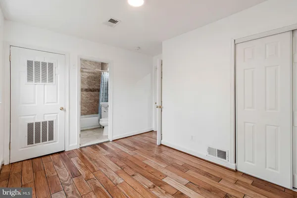a view of a room with wooden floor and entryway