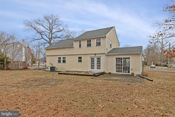 a front view of a house with a yard covered with snow