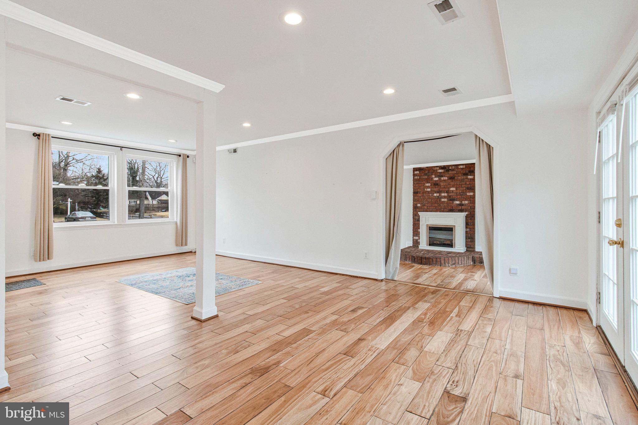 8600 Lantern Lane Clinton, MD 20735 - Photo 6 of 40 a view of an empty room with wooden floor and a window
