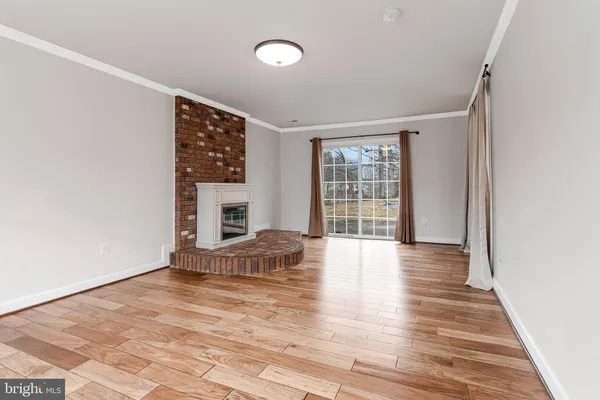 wooden floor in an empty room with a fireplace