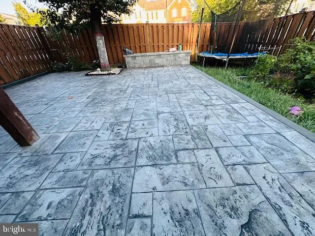 a view of garden with wooden fence