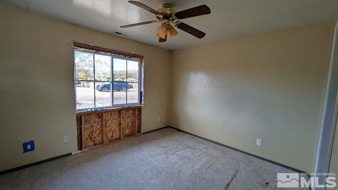 1355 Antelope Valley Road Reno, NV 89506 - Photo 21 of 25 an empty room with chandelier fan and windows