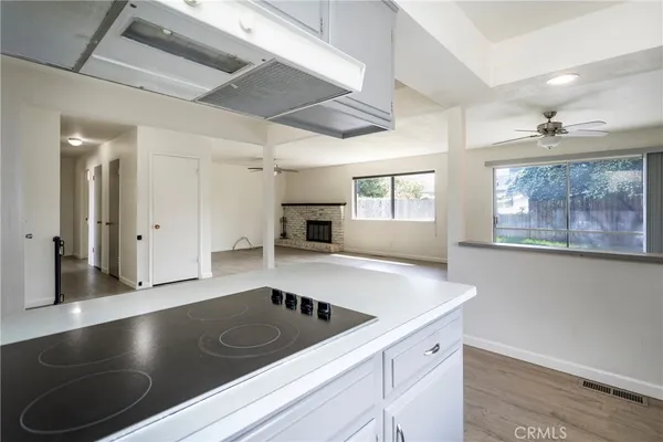 a view of kitchen with a sink stainless steel appliances and cabinets