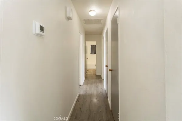 a view of a hallway with wooden floor