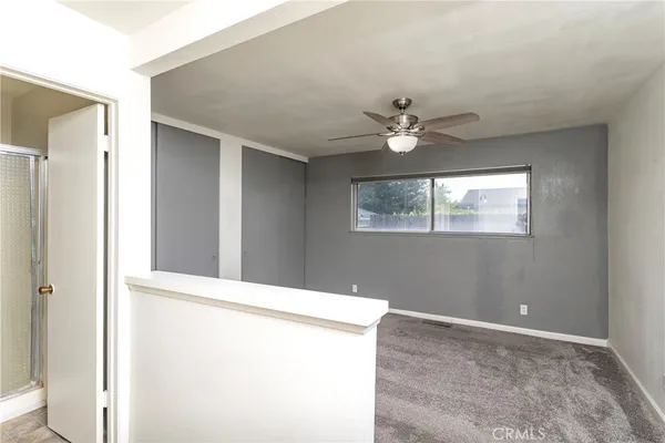 a view of an empty room with windows