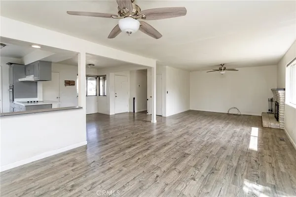 a view of a kitchen with wooden floor and a kitchen space
