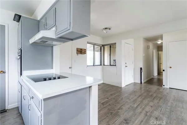 a kitchen with stainless steel appliances granite countertop a sink and a refrigerator
