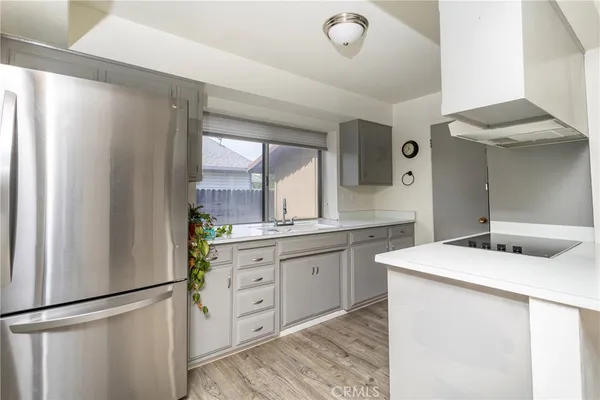 a kitchen with a refrigerator and a sink
