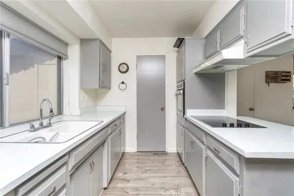 a kitchen with stainless steel appliances granite countertop a sink and a refrigerator