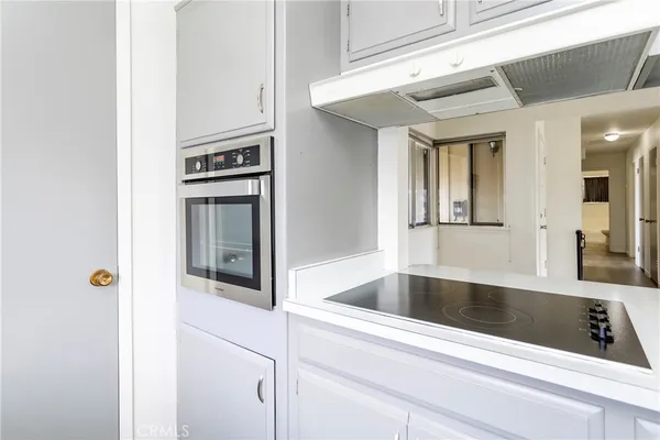 a kitchen with refrigerator and cabinets