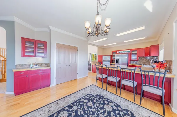 a kitchen with stainless steel appliances granite countertop a refrigerator and stove
