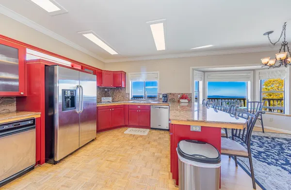 a kitchen with a stove a refrigerator and cabinets