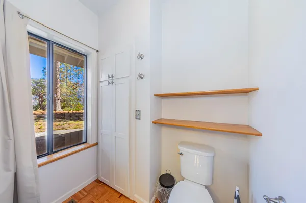 a bedroom with a bed and a ceiling fan