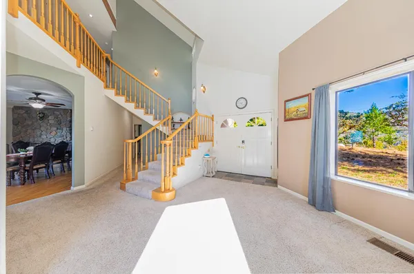 a view of an entryway with dining room and stairs