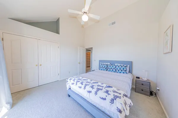 a view of a house with backyard and a tree