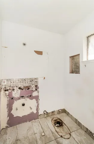 a view of a hallway with a chandelier fan