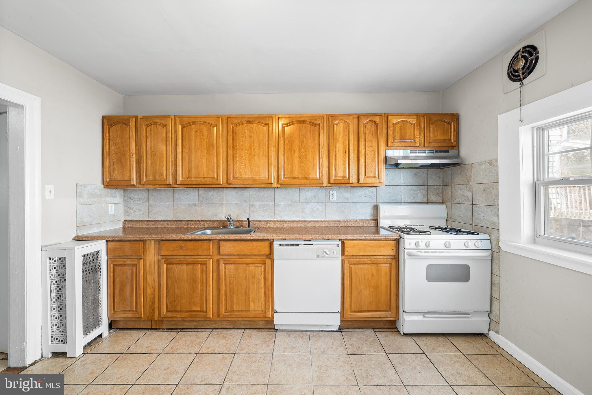 309 Sanford Road Upper Darby, PA 19082 - Photo 12 of 21 a kitchen with stainless steel appliances granite countertop a stove a sink and a microwave