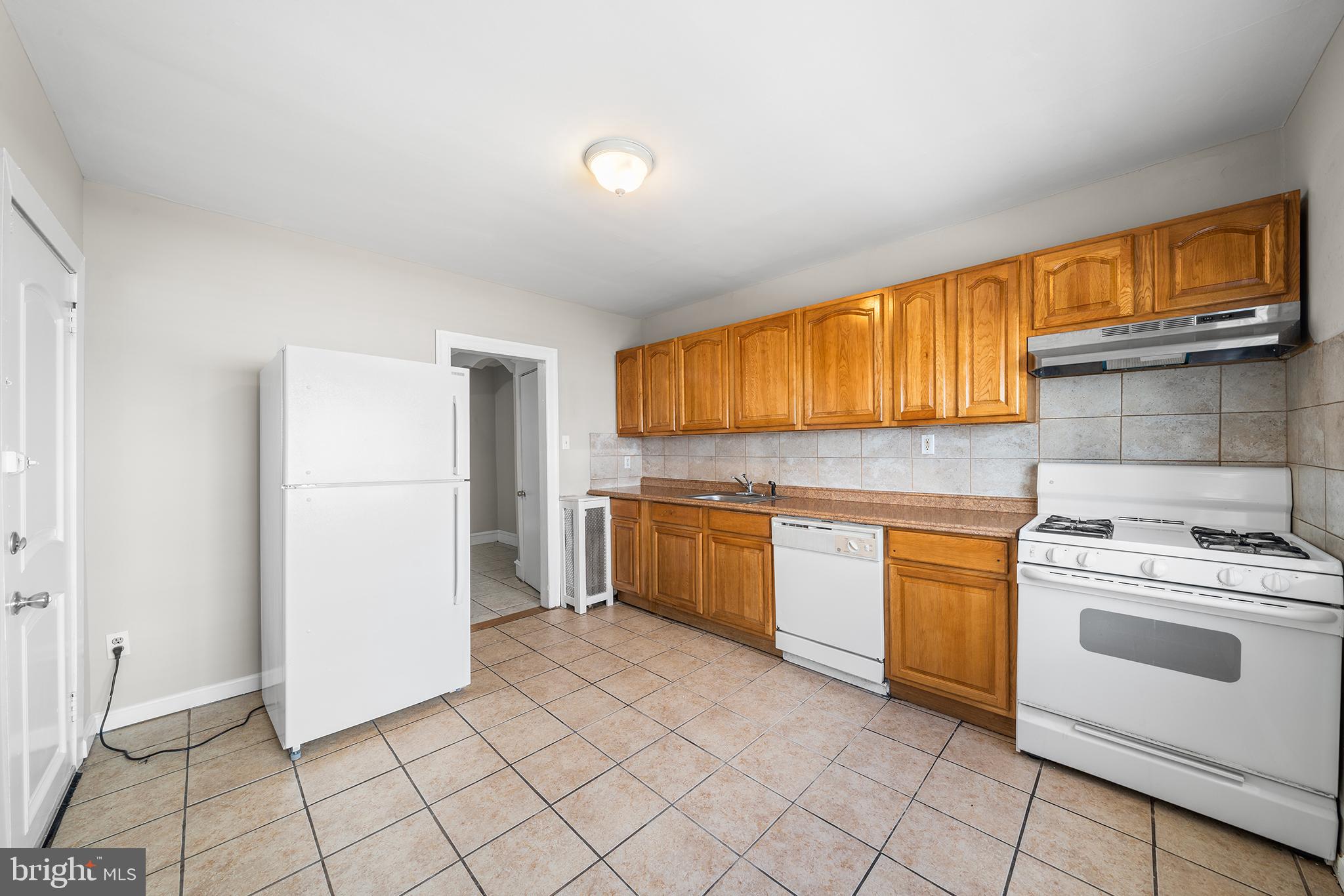 309 Sanford Road Upper Darby, PA 19082 - Photo 13 of 21 a kitchen with a stove a sink and a refrigerator