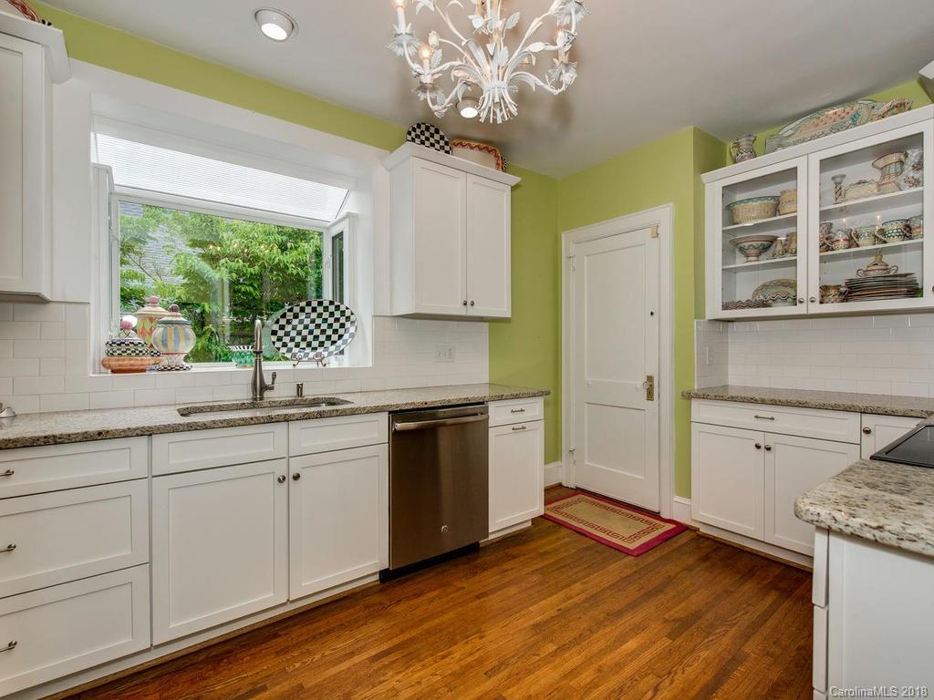 2174 Colony Road Charlotte, NC 28209 - Photo 13 of 24 a kitchen with a sink window and cabinets