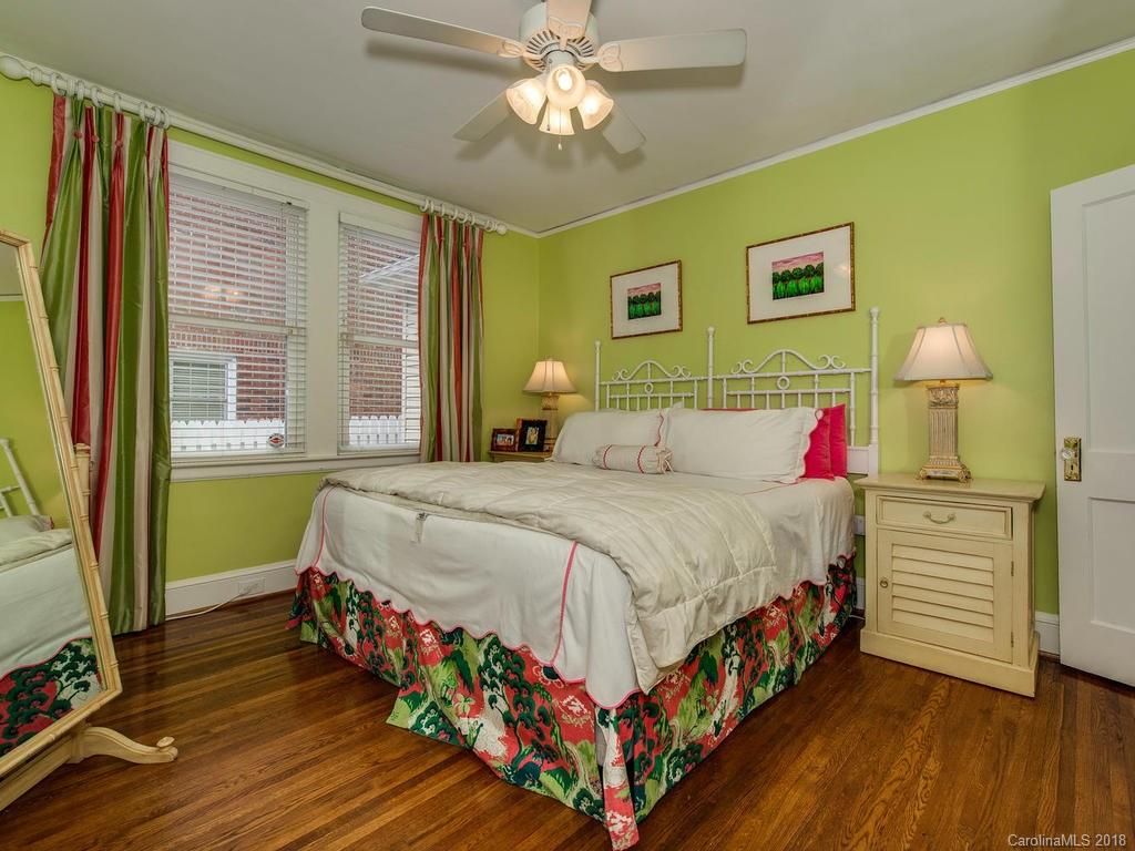 2174 Colony Road Charlotte, NC 28209 - Photo 14 of 24 a bedroom with a bed and a chandelier