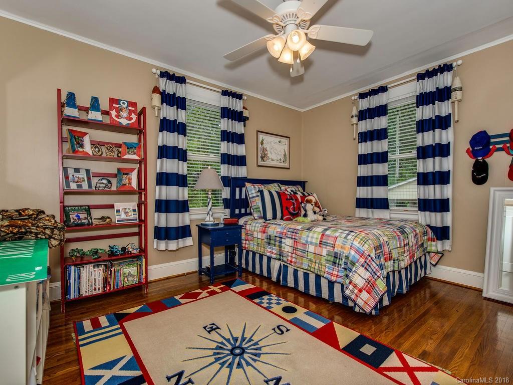2174 Colony Road Charlotte, NC 28209 - Photo 17 of 24 a bedroom with a bed and a book shelf