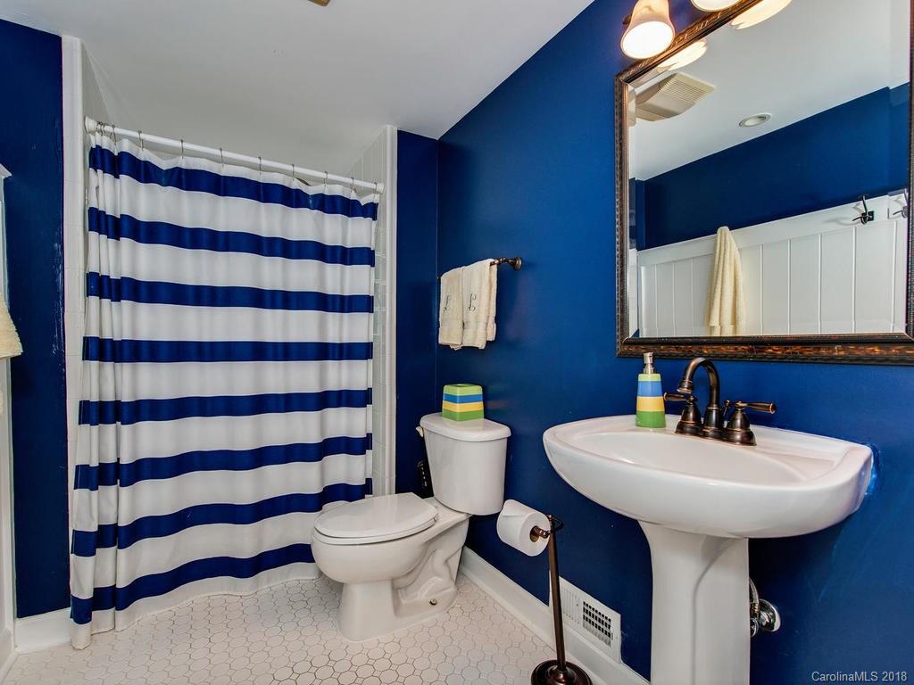 2174 Colony Road Charlotte, NC 28209 - Photo 22 of 24 a bathroom with a sink a toilet and mirror