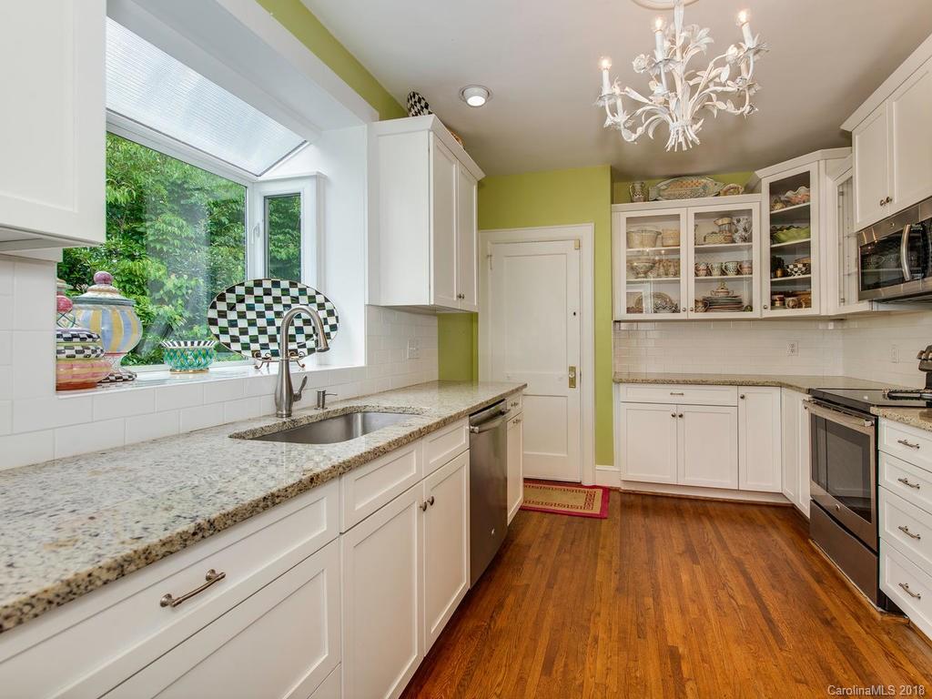 2174 Colony Road Charlotte, NC 28209 - Photo 10 of 24 a kitchen with granite countertop stainless steel appliances sink stove and cabinets