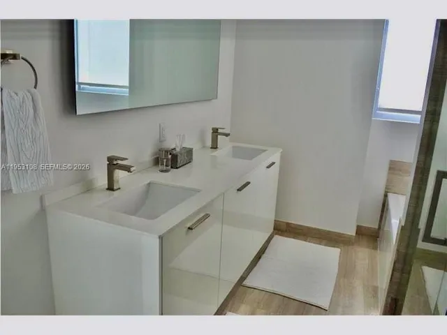 a bathroom with a sink a mirror and vanity