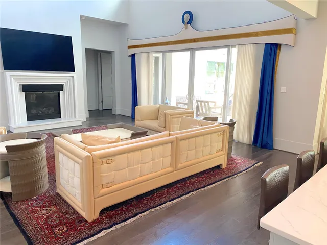 a living room with hard wood floors and a fireplace