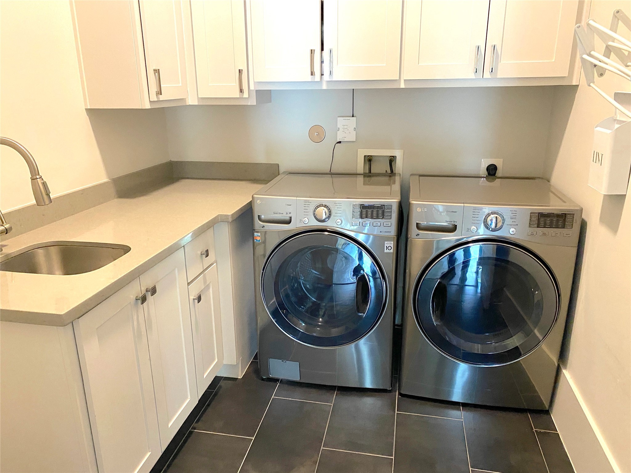 4642 Devon Street Houston, TX 77027 - Photo 15 of 39 a utility room with sink dryer and washer