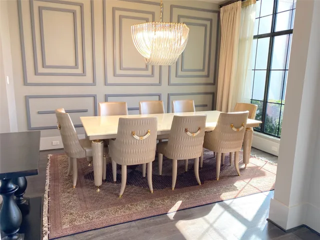 a view of a dining room with furniture and a chandelier
