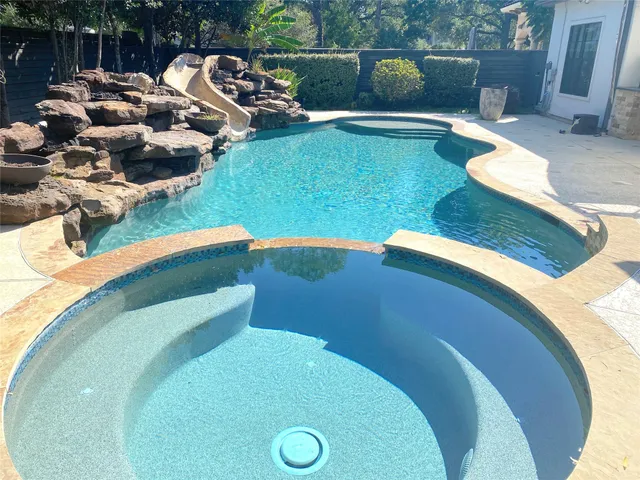 a view of swimming pool with seating space