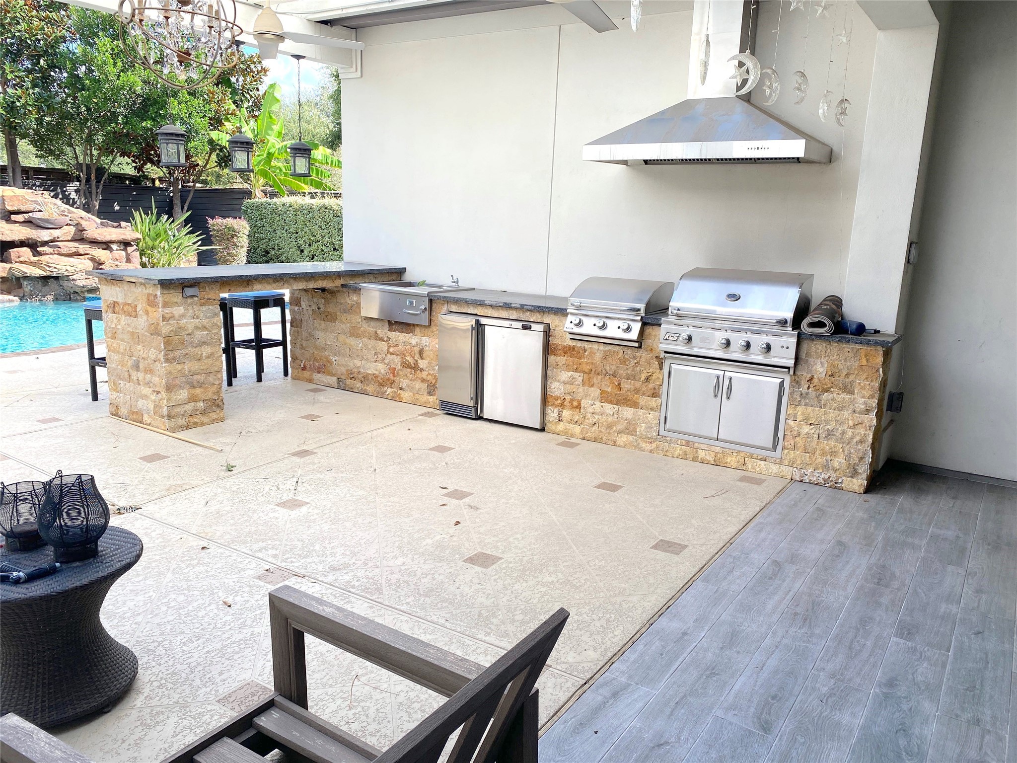 4642 Devon Street Houston, TX 77027 - Photo 35 of 39 a kitchen with stainless steel appliances wooden floor and a table chair
