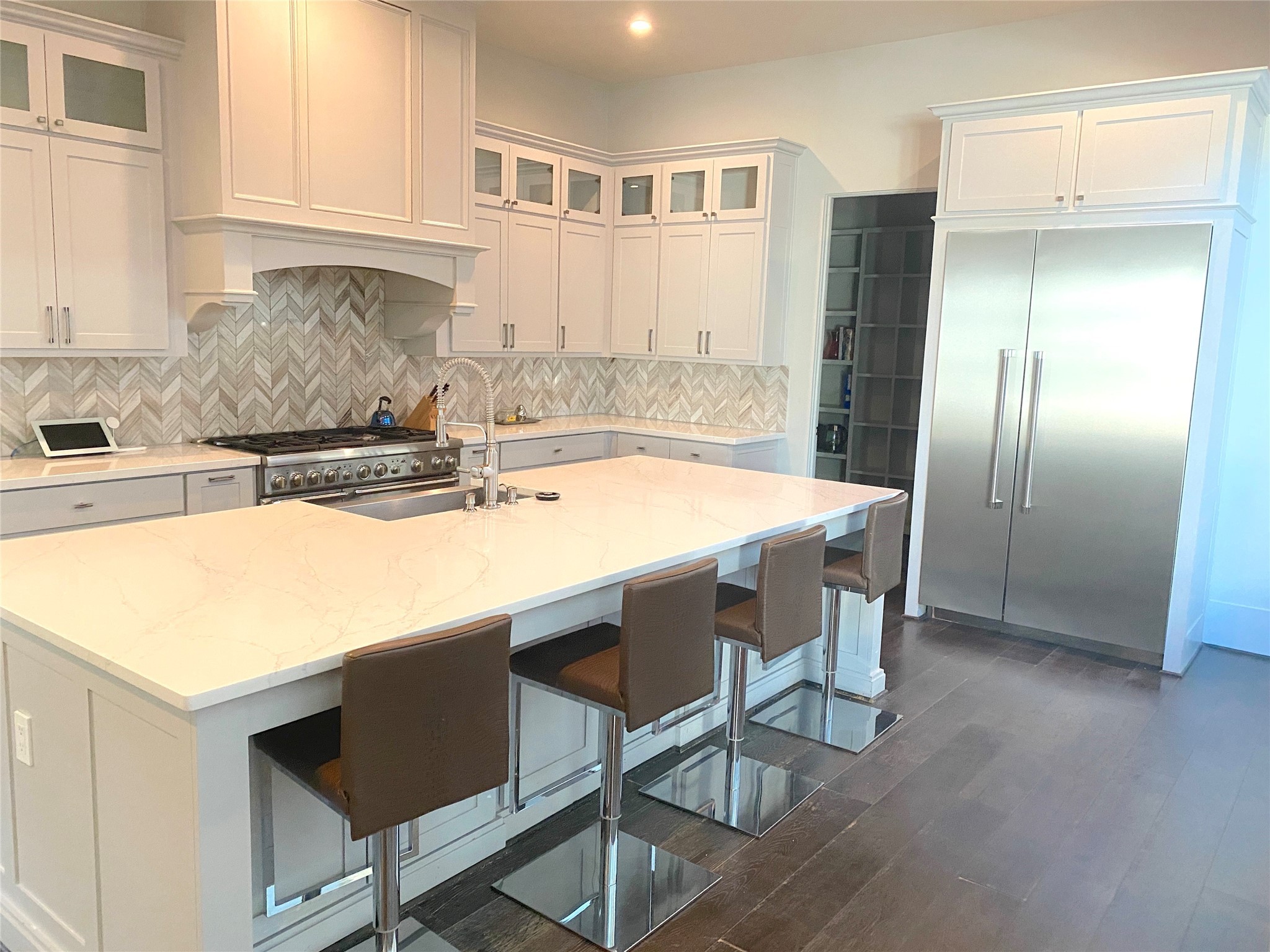 4642 Devon Street Houston, TX 77027 - Photo 7 of 39 a kitchen with stainless steel appliances granite countertop a sink a microwave a refrigerator and white cabinets