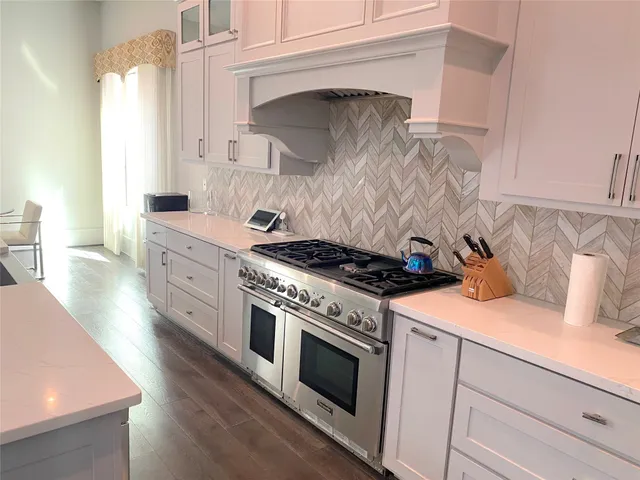 a kitchen with granite countertop a stove and a sink