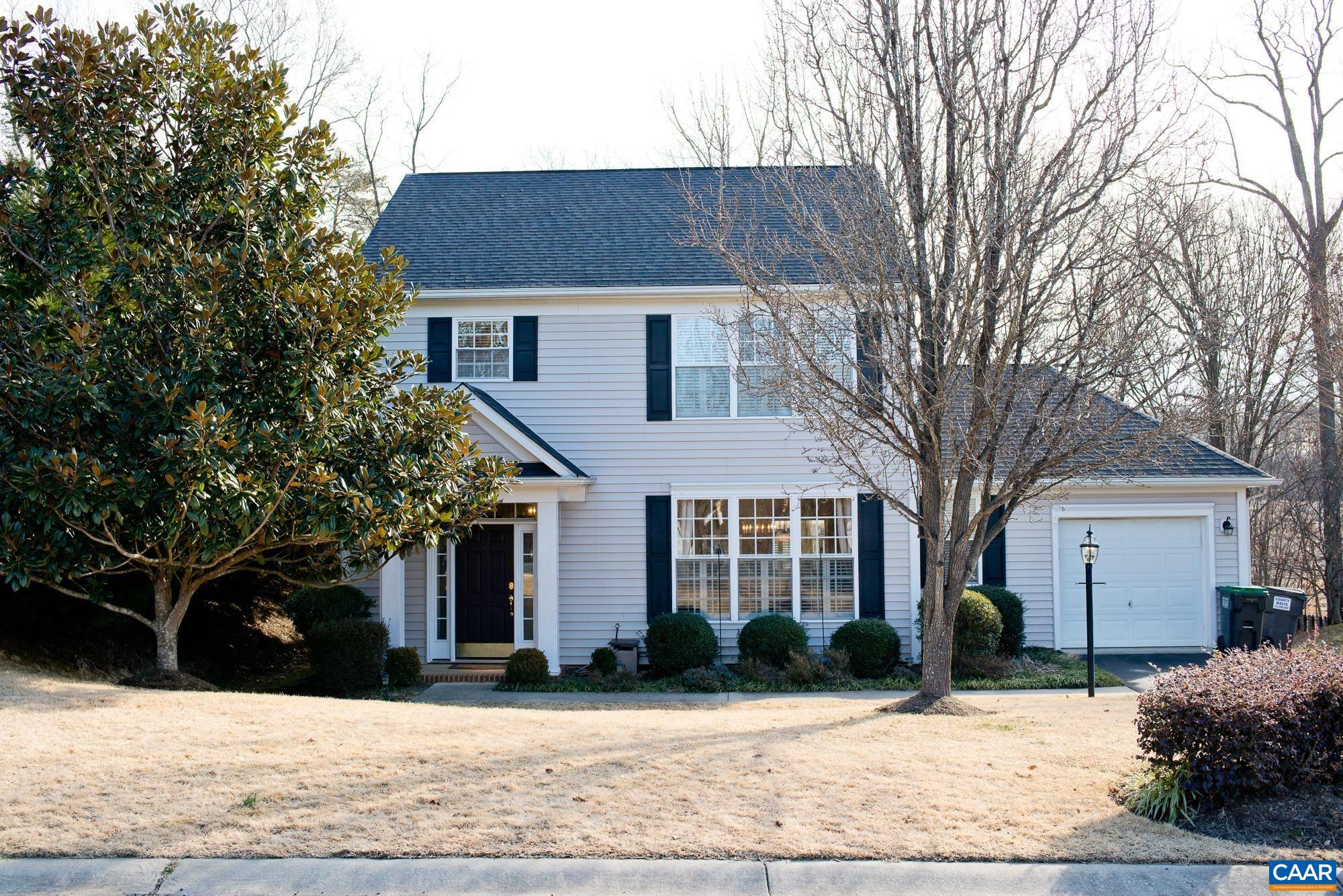 a front view of a house with a yard covered in snow