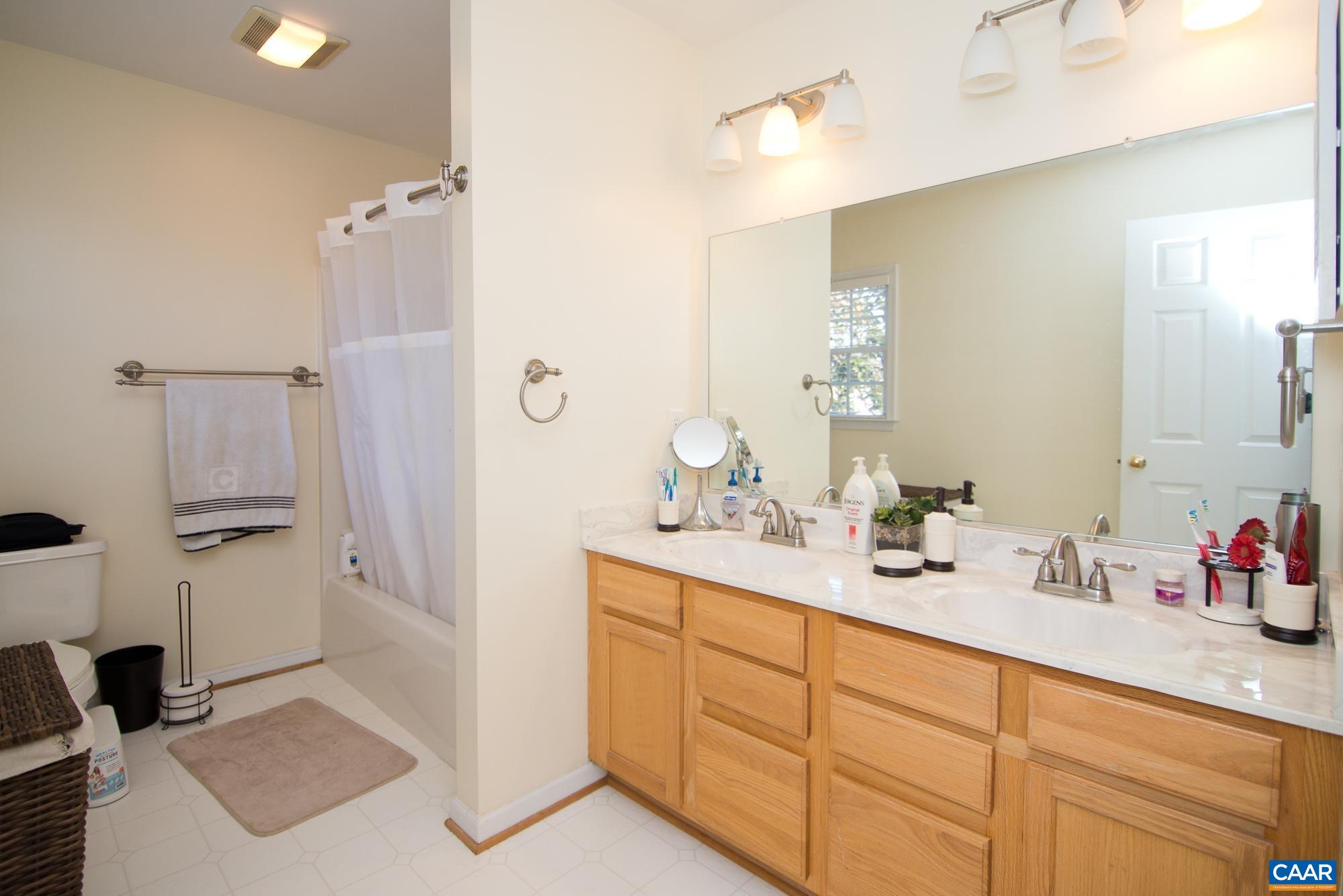 2986 Magnolia Bend Charlottesville, VA 22911 - Photo 15 of 22 a spacious bathroom with double vanity a mirror and shower