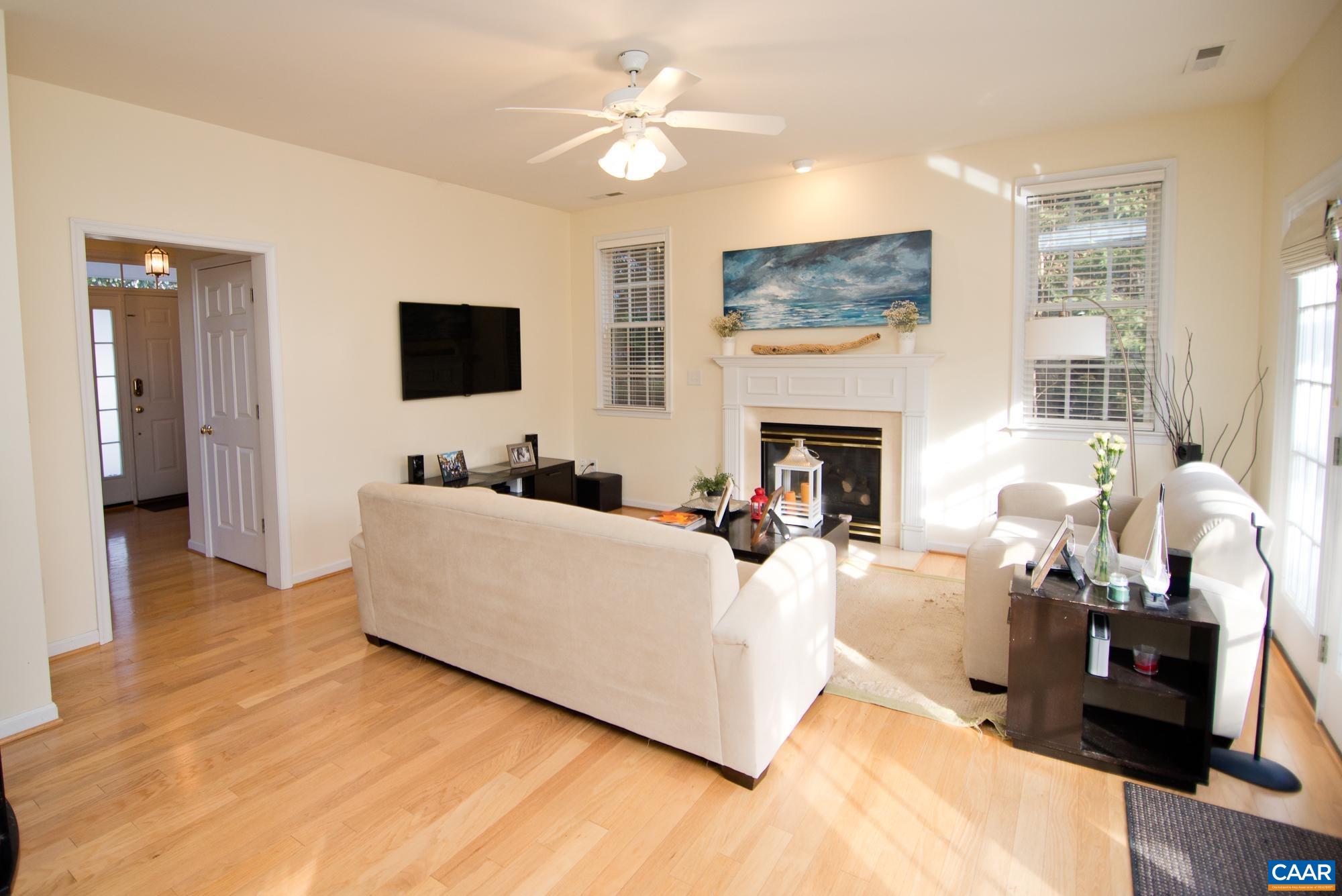 2986 Magnolia Bend Charlottesville, VA 22911 - Photo 6 of 22 a living room with furniture a flat screen tv and a fireplace