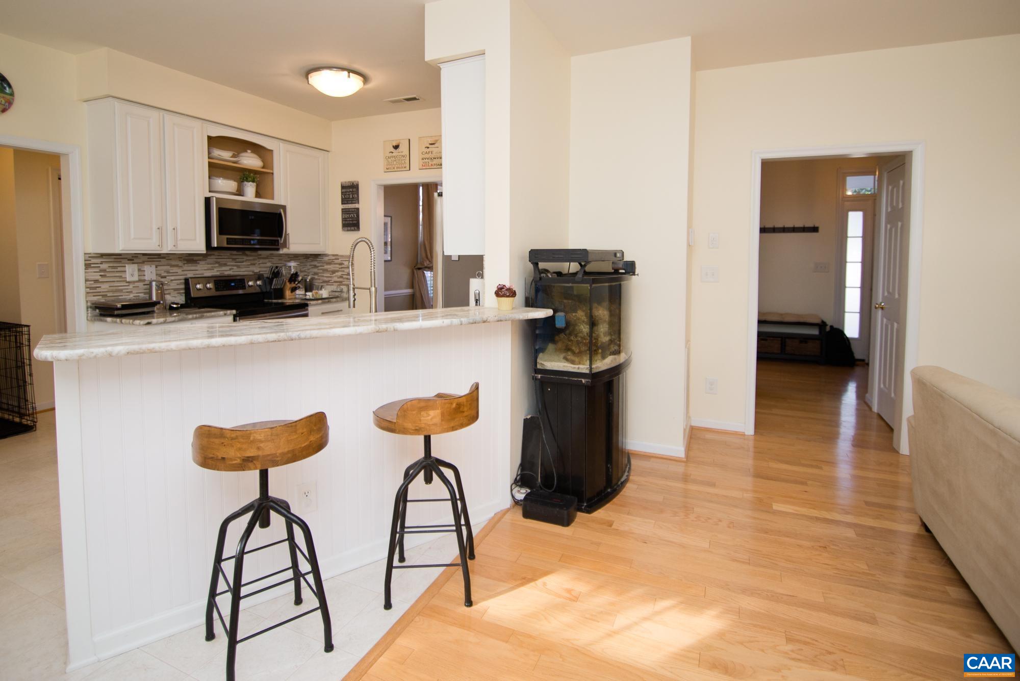 2986 Magnolia Bend Charlottesville, VA 22911 - Photo 7 of 22 a kitchen with stainless steel appliances kitchen island granite countertop a refrigerator and a stove top oven