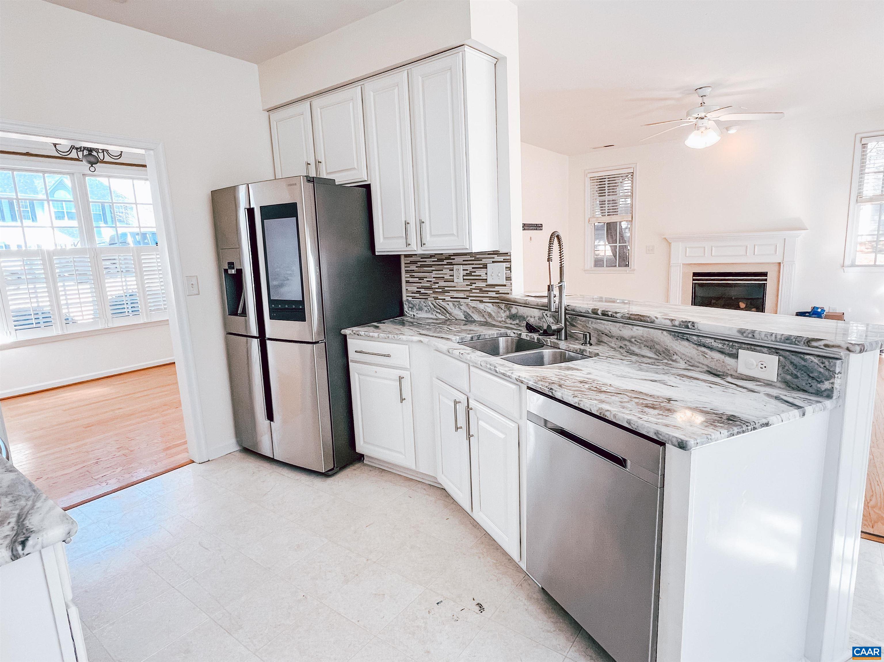 2986 Magnolia Bend Charlottesville, VA 22911 - Photo 9 of 22 a kitchen with stainless steel appliances granite countertop a refrigerator a stove a sink and a granite counter tops with white cabinets
