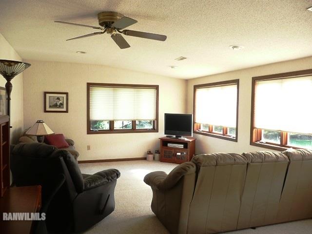 12982 North Bluff Road Baileyville, IL 61007 - Photo 11 of 25 a living room with furniture window and a flat screen tv