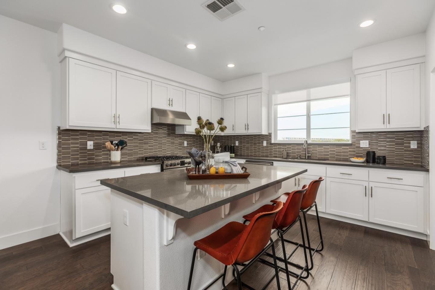 142 Cue Way Hayward, CA 94544 - Photo 9 of 24 a kitchen with a stove a sink a microwave a dining table and chairs