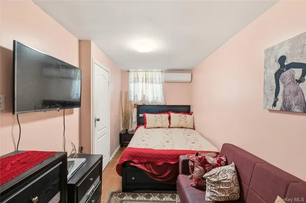 a bedroom with a bed and a flat screen tv
