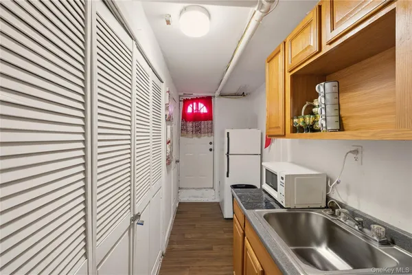 a kitchen with a refrigerator and a sink