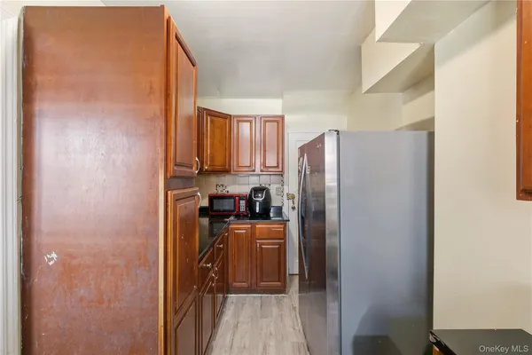 a kitchen with stainless steel appliances granite countertop a refrigerator and a stove top oven