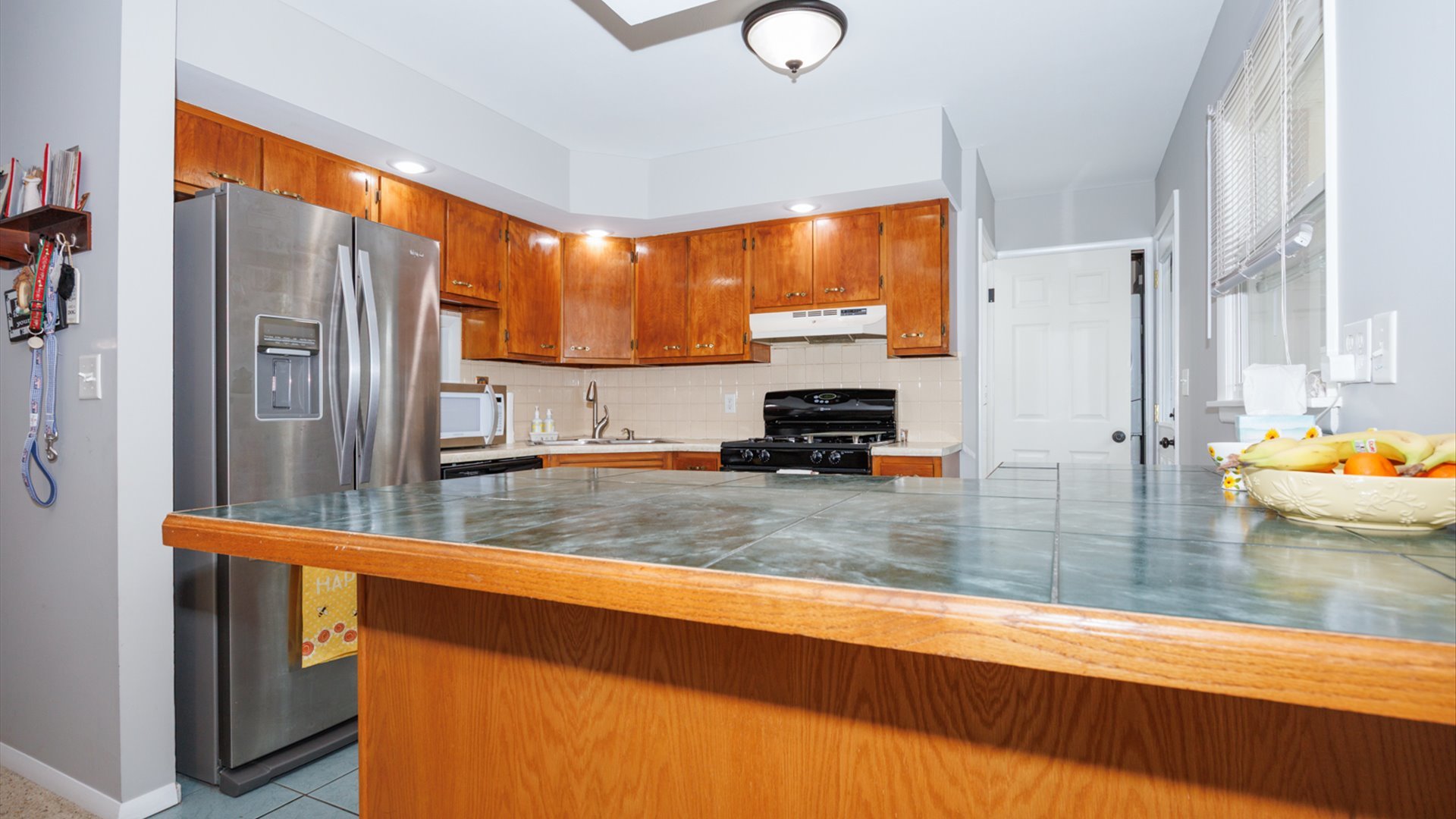 407 Tilden Place Normal, IL 61761 - Photo 13 of 49 a kitchen with stainless steel appliances a sink window and a counter top space