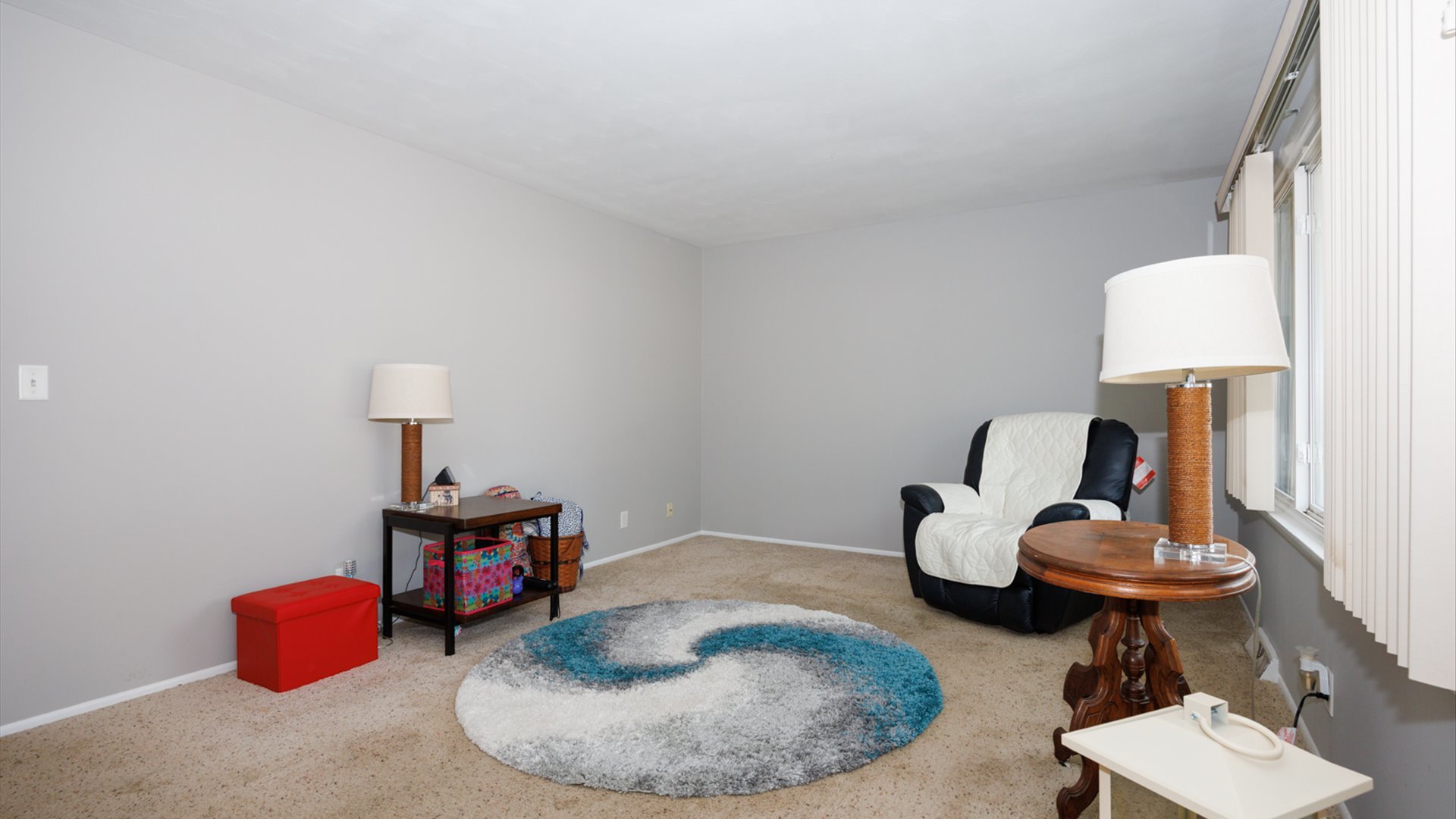 407 Tilden Place Normal, IL 61761 - Photo 25 of 49 a room with furniture and a lamp