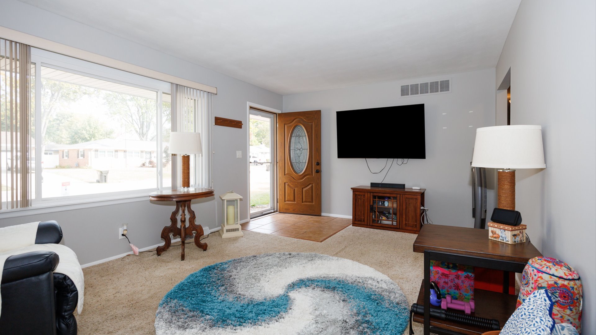 407 Tilden Place Normal, IL 61761 - Photo 3 of 49 a living room with furniture a flat screen tv and a fireplace