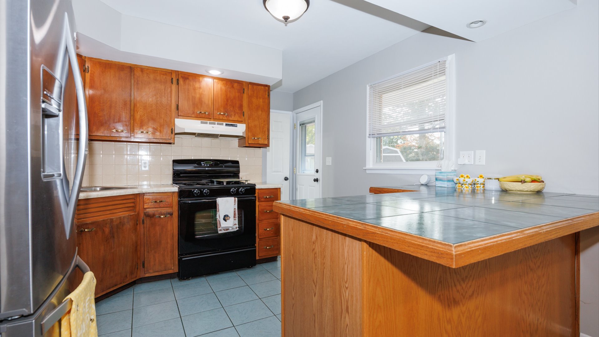 407 Tilden Place Normal, IL 61761 - Photo 10 of 49 a kitchen with stainless steel appliances granite countertop a refrigerator a sink dishwasher a stove and white countertops with wooden floor